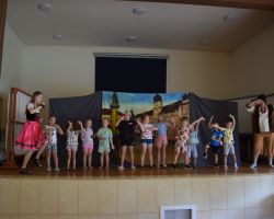 Dzieci na scenie z osobą przebraną za postać z bajek