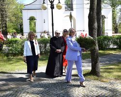 Pani wójt z wiązanką kwiatów pod pomnikiem niepodległości